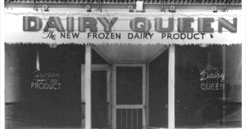 Black and white image of a Dairy Queen storefront with a sign reading "The New Frozen Dairy Product."