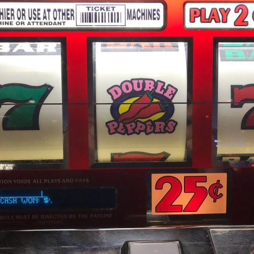 A close-up of a slot machine displaying the "Double Peppers" symbol and a 25-cent play option.