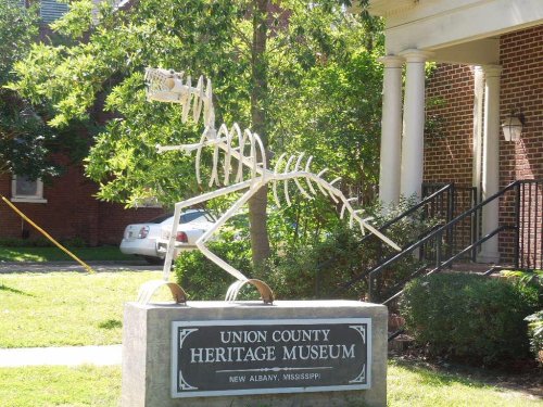 A dinosaur skeleton sculpture stands in front of the Union County Heritage Museum in New Albany, Mississippi.