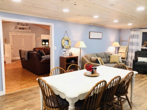 Cozy living space featuring a dining table, comfortable seating, and warm lighting in a welcoming atmosphere.