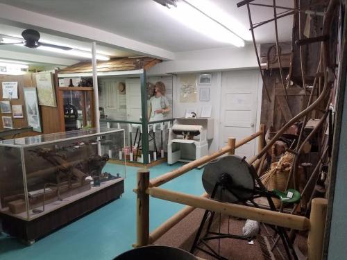 A museum interior featuring exhibits, including a display case and various historical artifacts.