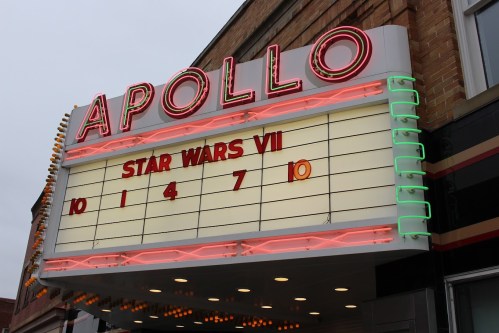 Marquee of the Apollo Theater displaying "Star Wars VII" showtimes: 10, 1, 4, 7, 10. Neon lights and retro design.