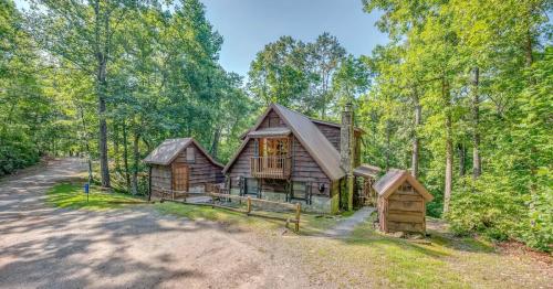 A rustic cabin surrounded by lush green trees, with a gravel path leading up to it.