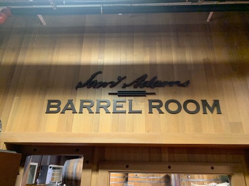 Sign on a wooden wall reading "Sand Stevens BARREL ROOM" in bold letters.