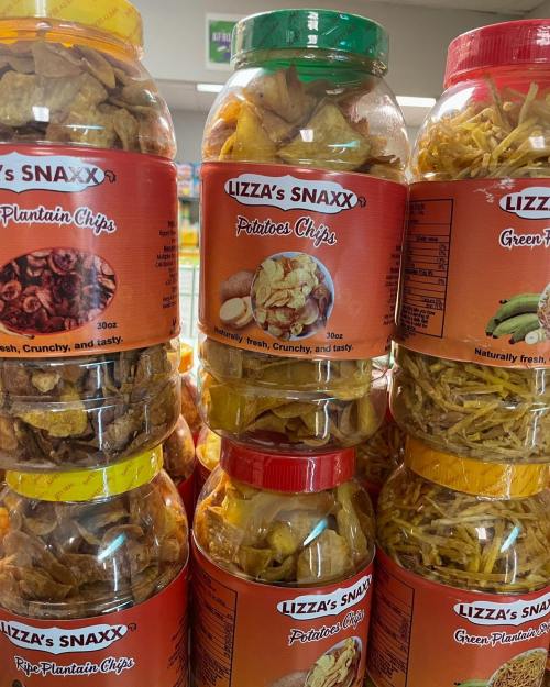 A stack of jars filled with various snacks, including plantain chips, potato chips, and green plantain chips.