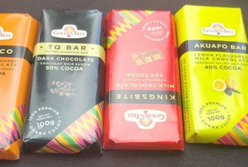 Four chocolate bars in colorful packaging: Golden Tree, TQ Bar, Kingsbite, and Akufo, showcasing various flavors and cocoa content.