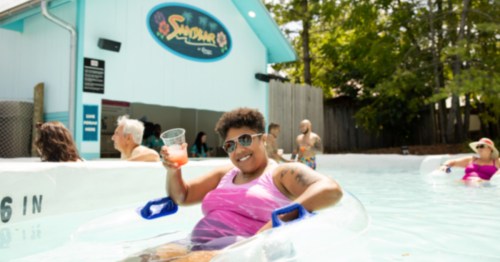 A woman in a pink bathing suit lounges in the pool at an Ohio swim-up bar