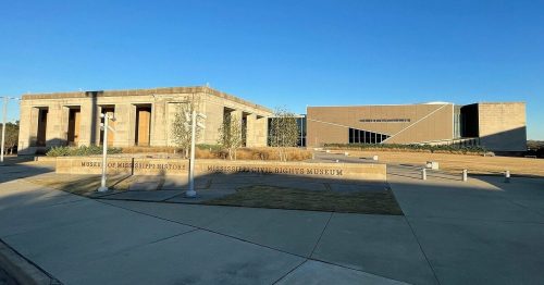 Exterior view of the Museum of Mississippi History and Mississippi Civil Rights Museum under a clear blue sky.