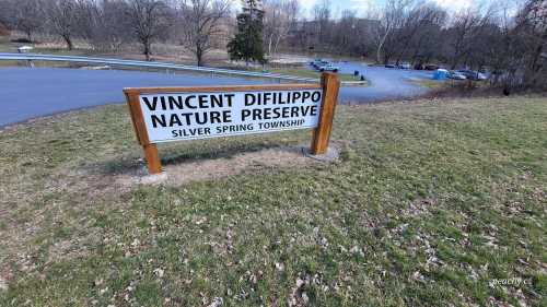 Sign for Vincent Difilippo Nature Preserve in Silver Spring Township, surrounded by grass and trees.