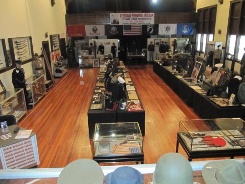 Interior of the Veterans Memorial Museum, showcasing military artifacts and memorabilia in a spacious exhibit area.