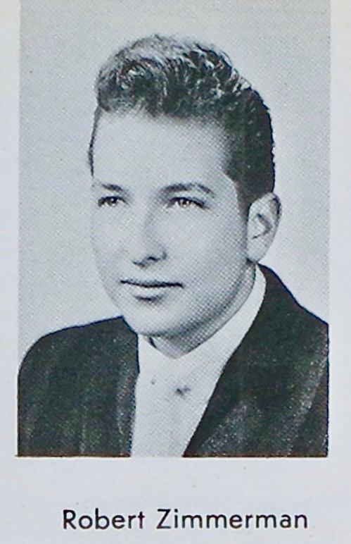 Black and white yearbook photo of a young man with styled hair, wearing a suit and tie, labeled "Robert Zimmerman."