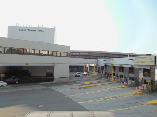 View of the Detroit-Windsor Tunnel entrance with vehicles and parking structures in the background.