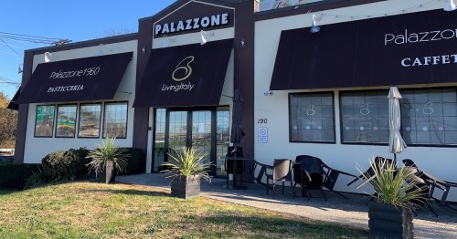Exterior of Palazzone café with large windows, outdoor seating, and a sign featuring the name and logo.
