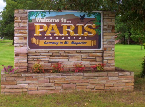 Sign welcoming visitors to Paris, Arkansas, featuring the text "Gateway to Mt. Magazine" and surrounded by greenery.