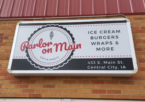 Sign for "Parlor on Main" featuring ice cream, burgers, wraps, and more, located at 433 E. Main St., Central City, IA.