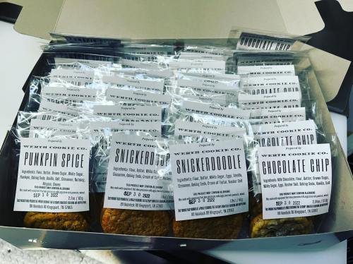 A box of assorted cookies labeled pumpkin spice, snickerdoodle, and chocolate chip, neatly packaged.