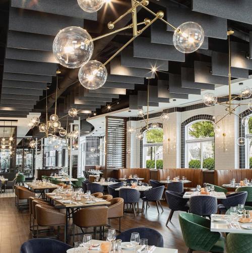 Modern restaurant interior with stylish lighting, elegant tables, and cozy seating arrangements.