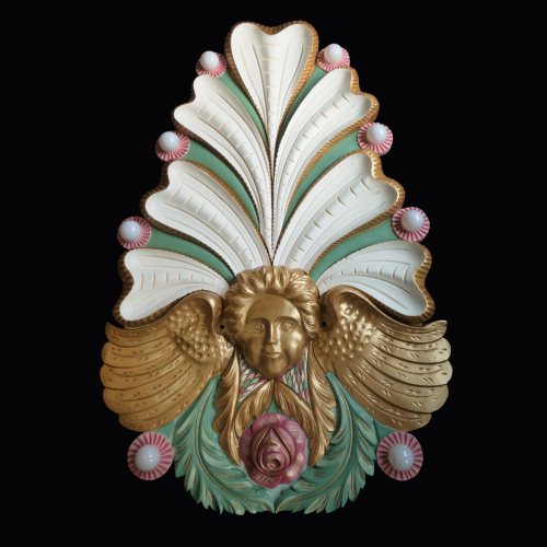Ornate decorative wall piece featuring intricate floral and feather designs in gold, green, and pink hues.