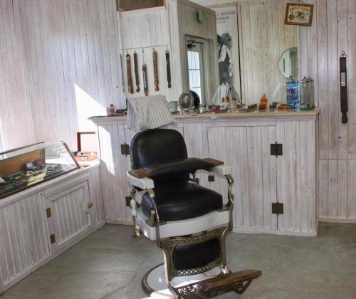 A vintage barber shop interior featuring a classic barber chair and wooden decor.