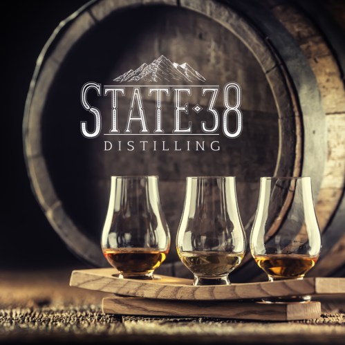 Three whiskey glasses on a wooden tray in front of a barrel, with "State 38 Distilling" logo above.
