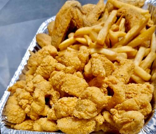 A tray filled with crispy fried chicken wings and golden French fries.