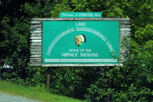 Sign welcoming visitors to Webster, MA, featuring text about Lake Chargoggagoggmanchauggagoggchaubunagungamaugg and the Nipmuc Indians.