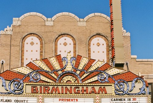 Colorful marquee of the Birmingham theater, featuring "Carmen in 3D" against a clear blue sky.