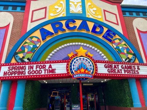 Colorful arcade entrance with a sign reading "Spring in for a hopping good time" and "Great games & great prizes."