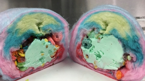 A colorful, swirled dessert with layers of pastel cotton candy and mint ice cream, filled with cereal pieces.