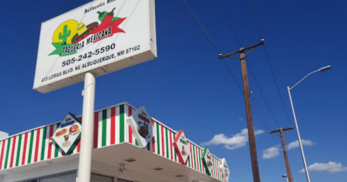 A colorful restaurant sign with a blue sky and power lines in the background, featuring green and red stripes.