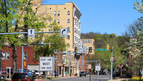 view of downtown clearfield pa on a clear sunny day with buildings, signs, and street lights visible against a blue sky