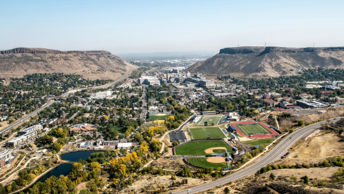 Aerial view of Golden, Colorado, with the town in the valley below, unique rock formations, and a blue sky overhead.