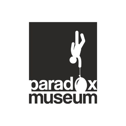 Logo of Paradox Museum featuring a figure hanging upside down from a circle, with the text "paradox museum" below.