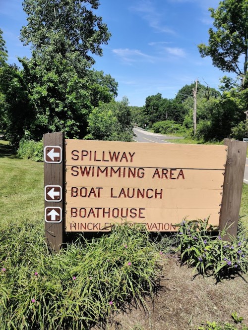 Signpost indicating directions to Spillway, Swimming Area, Boat Launch, and Boathouse at Hinckley Reservation.