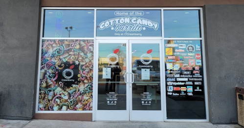 Storefront of Creamberry featuring colorful artwork and a sign for the Cotton Candy Burrito. Open hours displayed.