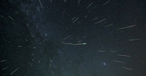 A starry night sky filled with numerous bright meteors streaking across the dark expanse of space.