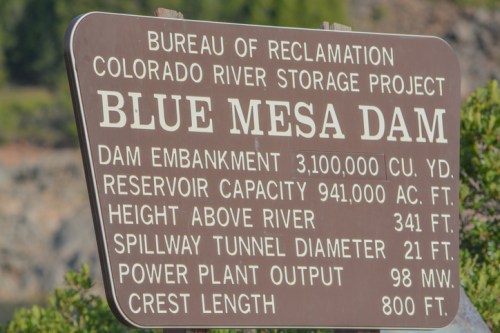 Sign for Blue Mesa Dam detailing its specifications, including capacity, height, and power output.