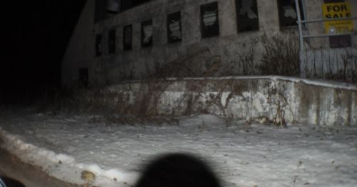 A an abandoned building at night.