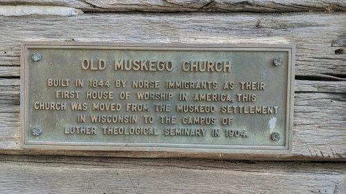 Plaque describing the Old Muskego Church, built in 1844 by Norse immigrants, moved to Luther Theological Seminary in 1904.