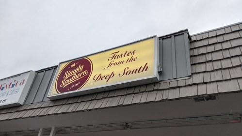 Sign for "Simply Southern Cuisine" with the tagline "Tastes from the Deep South" on a storefront.