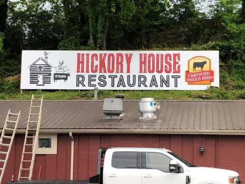 Sign for Hickory House Restaurant featuring BBQ and steaks, with a logo for Certified Angus Beef.