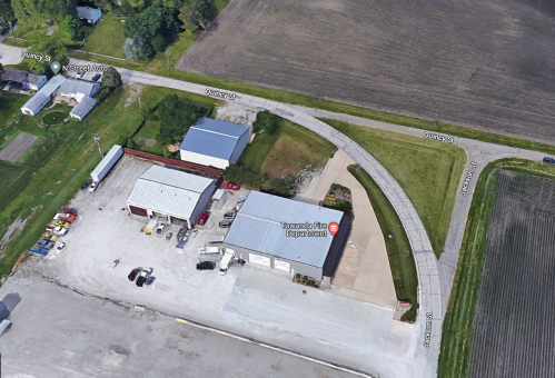 Aerial view of Towanda Fire Department with nearby streets and fields in a rural area.