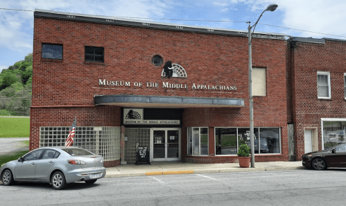 Exterior of the Museum of the Middle Appalachians, a brick building with large windows and an American flag.