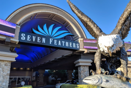 Entrance of Seven Feathers Casino Resort, featuring a large eagle statue and a blue-lit archway.