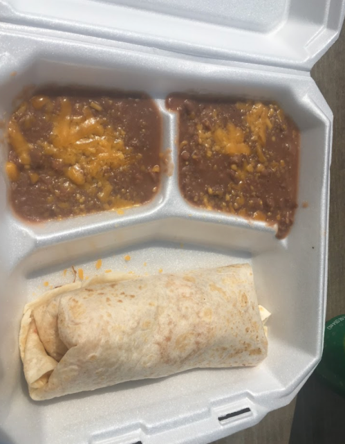 A takeout container with a burrito and two portions of refried beans topped with cheese.