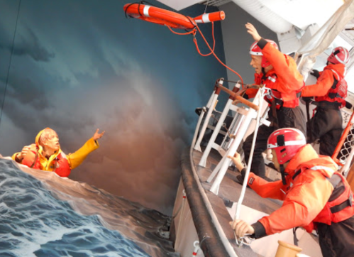 Rescue scene with lifeguards in orange gear reaching out to a person in distress in turbulent water.
