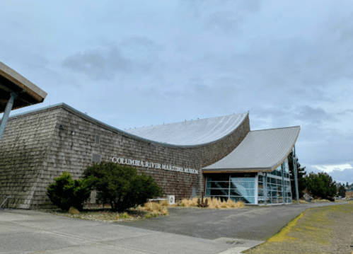 Exterior view of the Columbia River Maritime Museum, featuring a modern design and cloudy sky.
