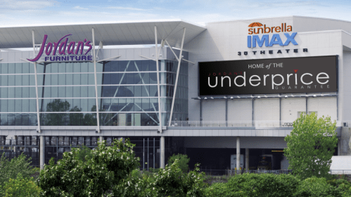Exterior view of a building featuring Jordan's Furniture and Sunbrella IMAX theater signage.