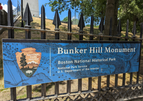Sign for Bunker Hill Monument at Boston National Historical Park, featuring the National Park Service logo.