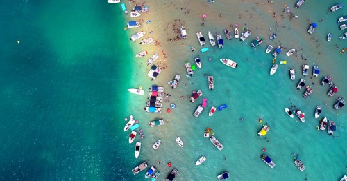 Aerial shot of Torch Lake sand bar, showing people and boats form above.